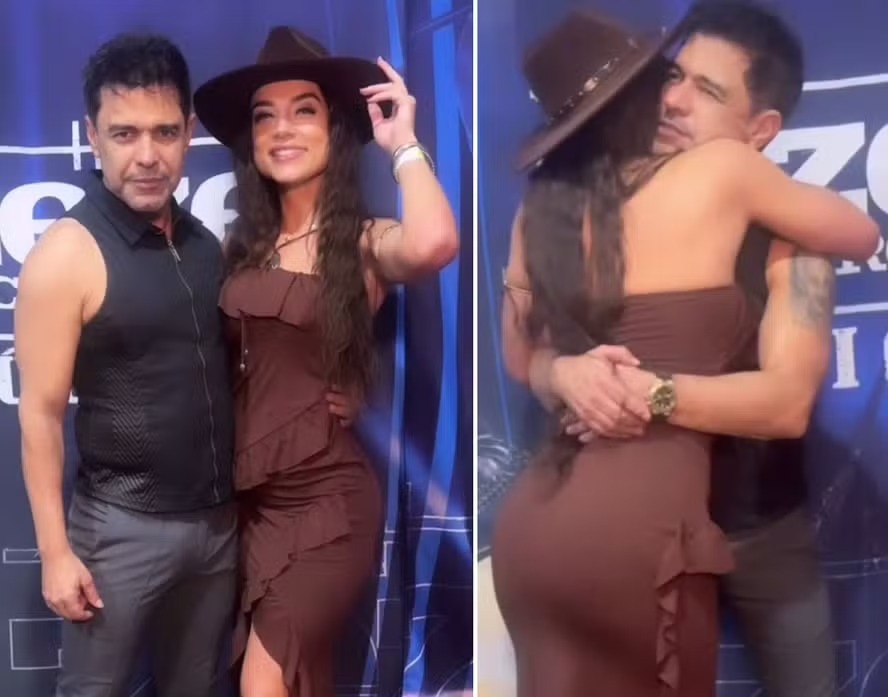 Zezé Di Camargo ao lado de fã e abraçando a fã.